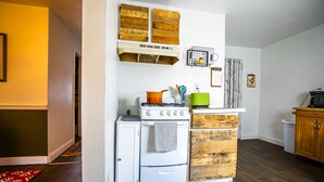 A compact kitchen with a stove, oven, and wooden cabinet. - Amazing Views- George Washington on Mt. Washington (Pittsburgh)