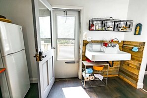 A compact kitchen with a white refrigerator, a sink, and a window. - Amazing Views- George Washington on Mt. Washington (Pittsburgh)