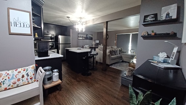 A modern living space with a kitchen, dining area, and a cozy seating area. - Cozy first floor condo with yard, near Keystone Resorts (Dillon)