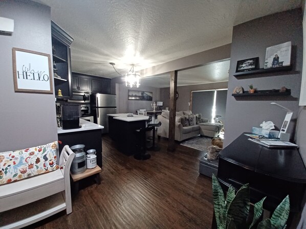 A modern living space with a kitchen, dining area, and a cozy seating area. - Cozy first floor condo with yard, near Keystone Resorts (Dillon)