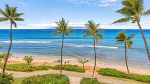 A beach with palm trees, a clear sky, and the ocean. - Maui Resort Rentals: Marriott's Maui Ocean Club Studio Oceanfront Suite (Lahaina)