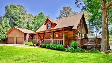 Enjoy a peaceful retreat in this charming cabin with a wrap-around porch and central chimney.