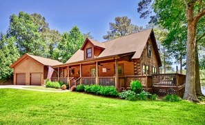 Enjoy a peaceful retreat in this charming cabin with a wrap-around porch and central chimney.