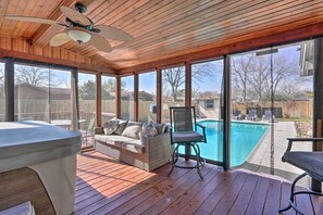 A covered outdoor area with a pool, wooden deck, and seating. - San Antonio Home w/ Pool, Near Lackland AFB! (San Antonio)