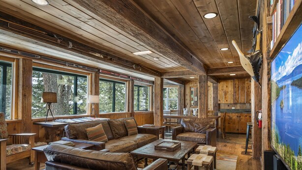 A rustic interior with wooden beams, leather furniture, and large windows offering natural light. - Rivendell - Escape at Historic Home in Olympic Valley, Near Village, Golf, and Minutes to Tahoe (Olympic Valley)