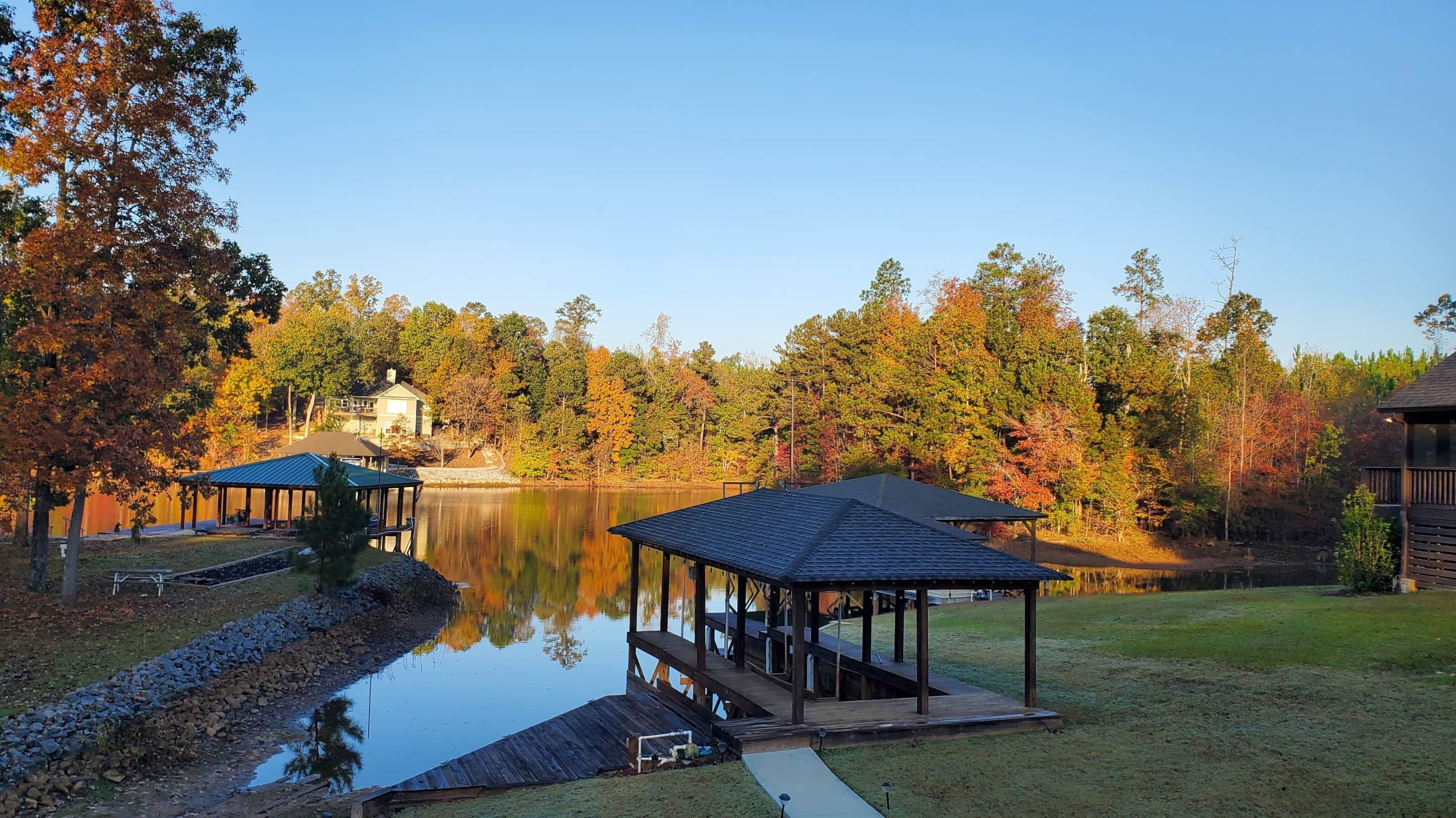 A lakeside cabin with a dock and a covered pavilion.