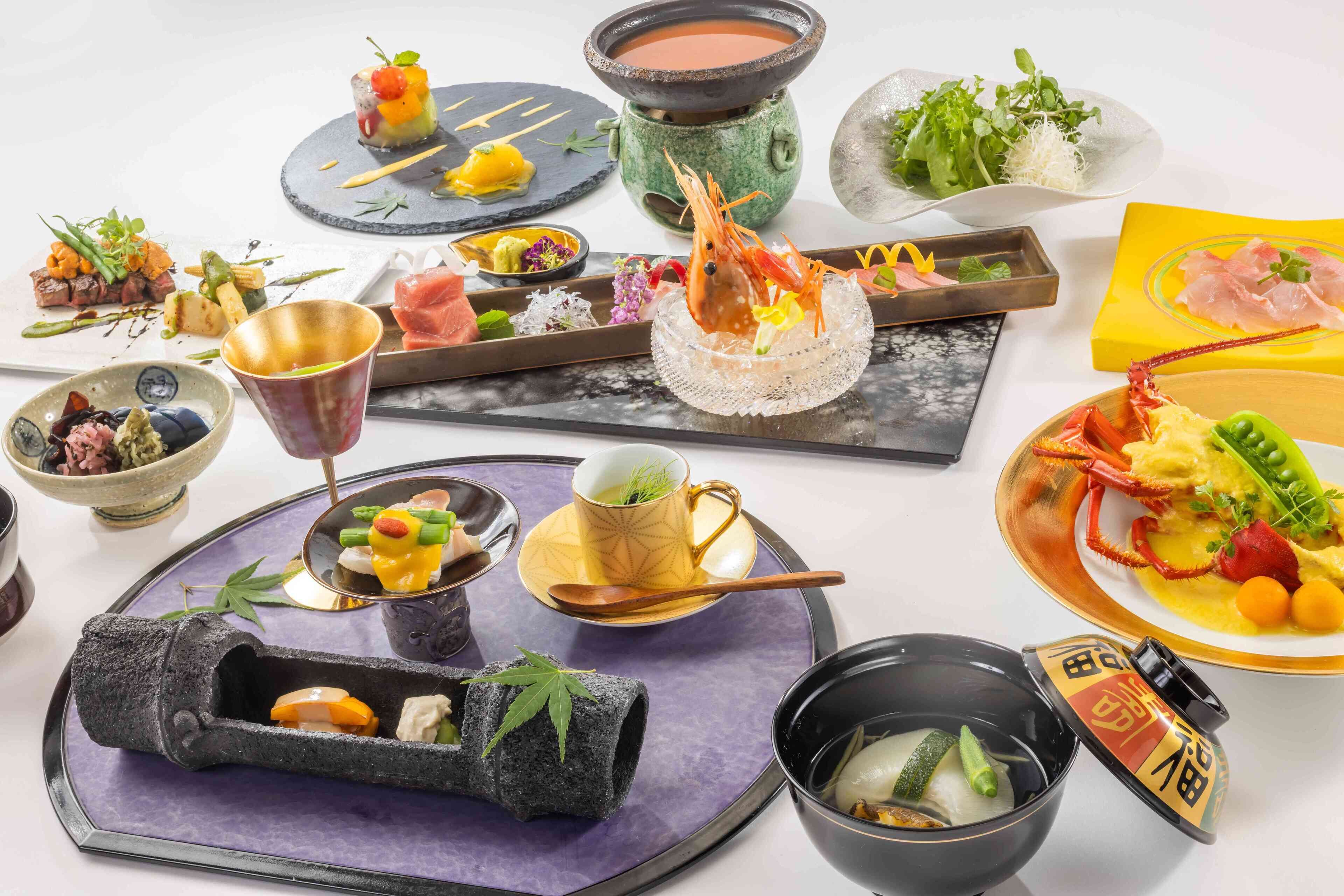 A variety of dishes and drinks on a table, including seafood, vegetables, and a hot pot.