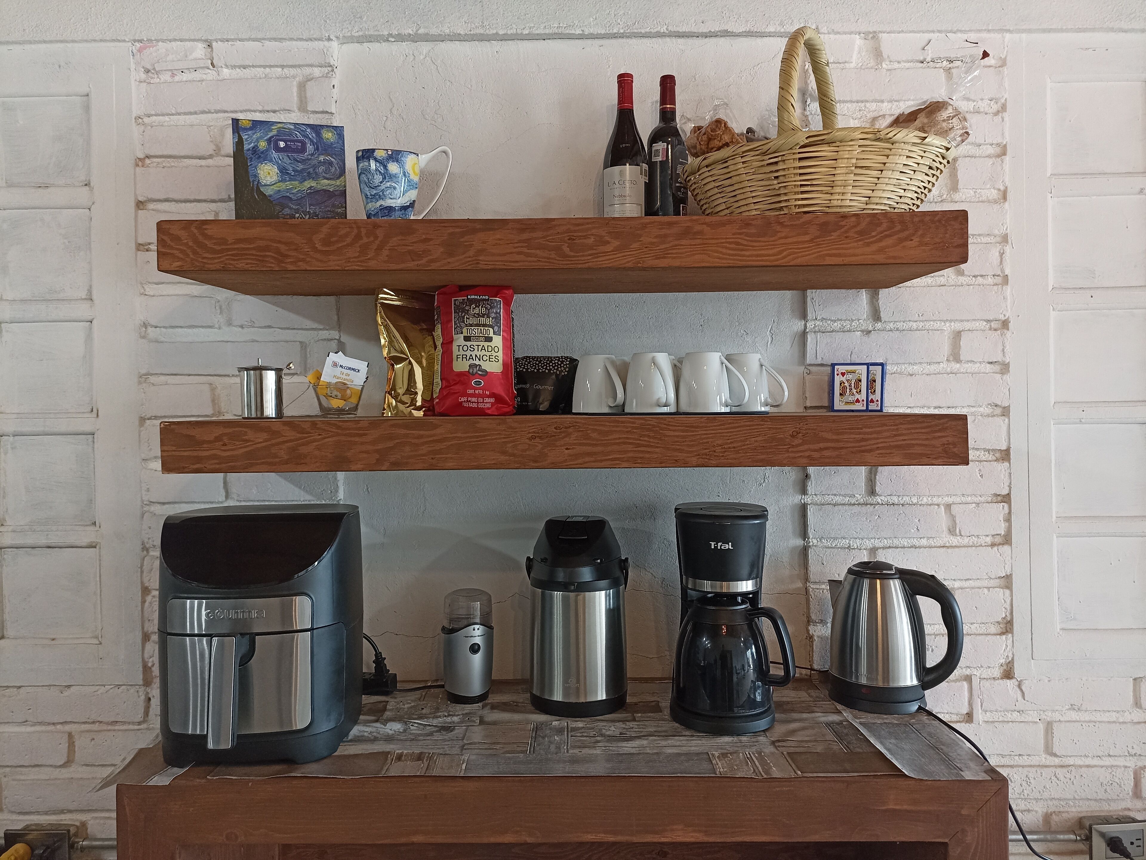 A kitchen with wooden shelves holding various items like coffee makers, a coffee pot, and a basket.