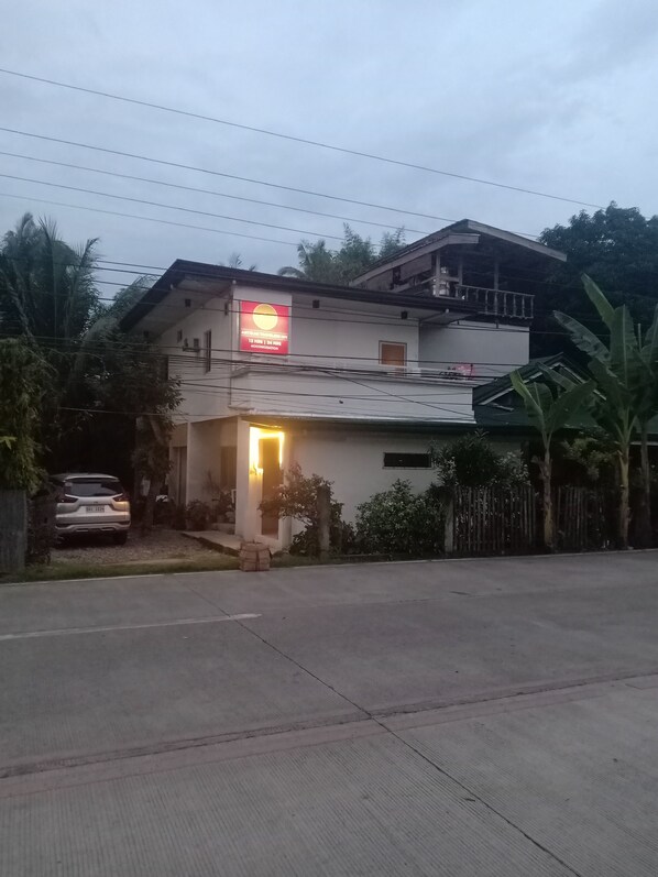 A two-story building with a sign indicating a 24-hour service.