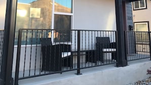 A modern building with a covered outdoor seating area, large windows, and a stone facade. - Book NOW for Summer Events! Located in downtown Salida! (Salida)