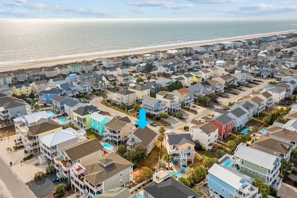 Coastal home with pool access, partial ocean views, outdoor shower, AC, & W/D