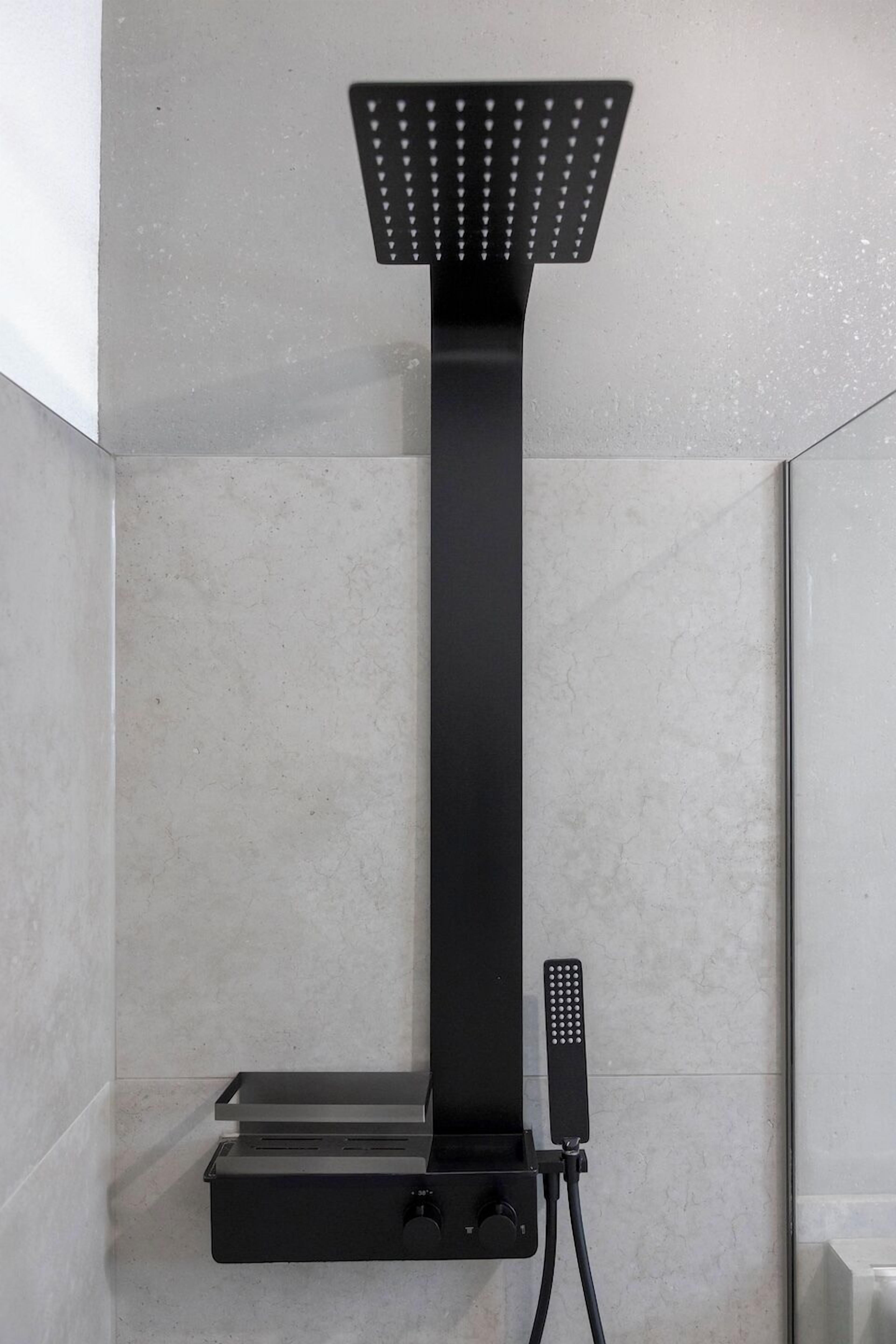 A modern shower with a square head and a control panel.