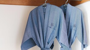 Two blue robes hanging on a metal rod. - Le Srivaree Suvaranabhumi Airport Hotel (Bang Phli)