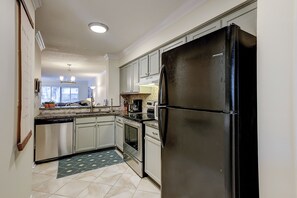 Enjoy cooking in this well-equipped kitchen with a refrigerator, oven, and dishwasher.