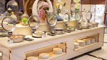 A buffet setup with various dishes and serving utensils.