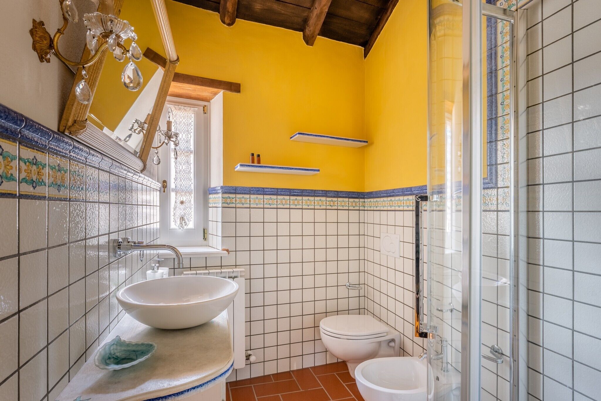 A bathroom with a white sink, a toilet, and a shower area.