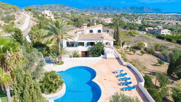 A villa with a swimming pool, sun loungers, and a view of the sea and hills. - Country House 'Na Penyal Ref 246' with Sea View, Private Pool and Wi-Fi (Cala Millor)