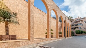 A building with arched windows and a stucco exterior.