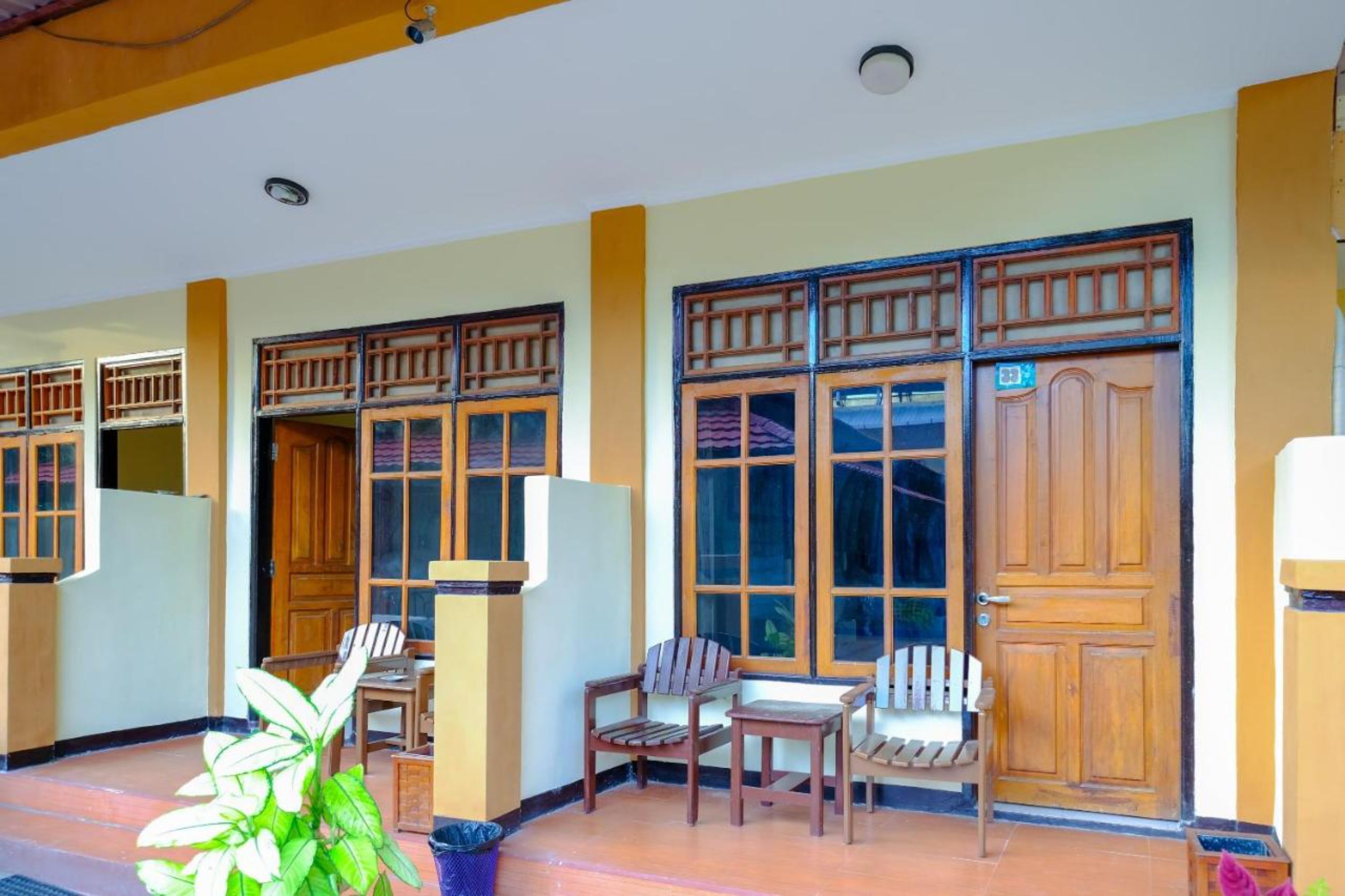 A room with wooden furniture, a large window, and a door.