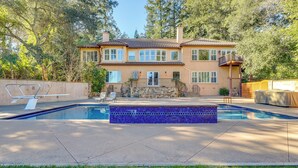 A two-story house with a swimming pool, stone facade, and a balcony. - Santa Rosa Home w/ Private Pool & Tennis Court (Santa Rosa)