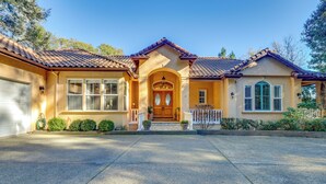 A two-story house with a front porch, a garage, and a well-maintained lawn. - Santa Rosa Home w/ Private Pool & Tennis Court (Santa Rosa)