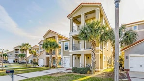 A residential building with a two-story structure, balconies, and a garage. - Sea-rendipity: Pool Access Near Perdido Beaches! (Pensacola)