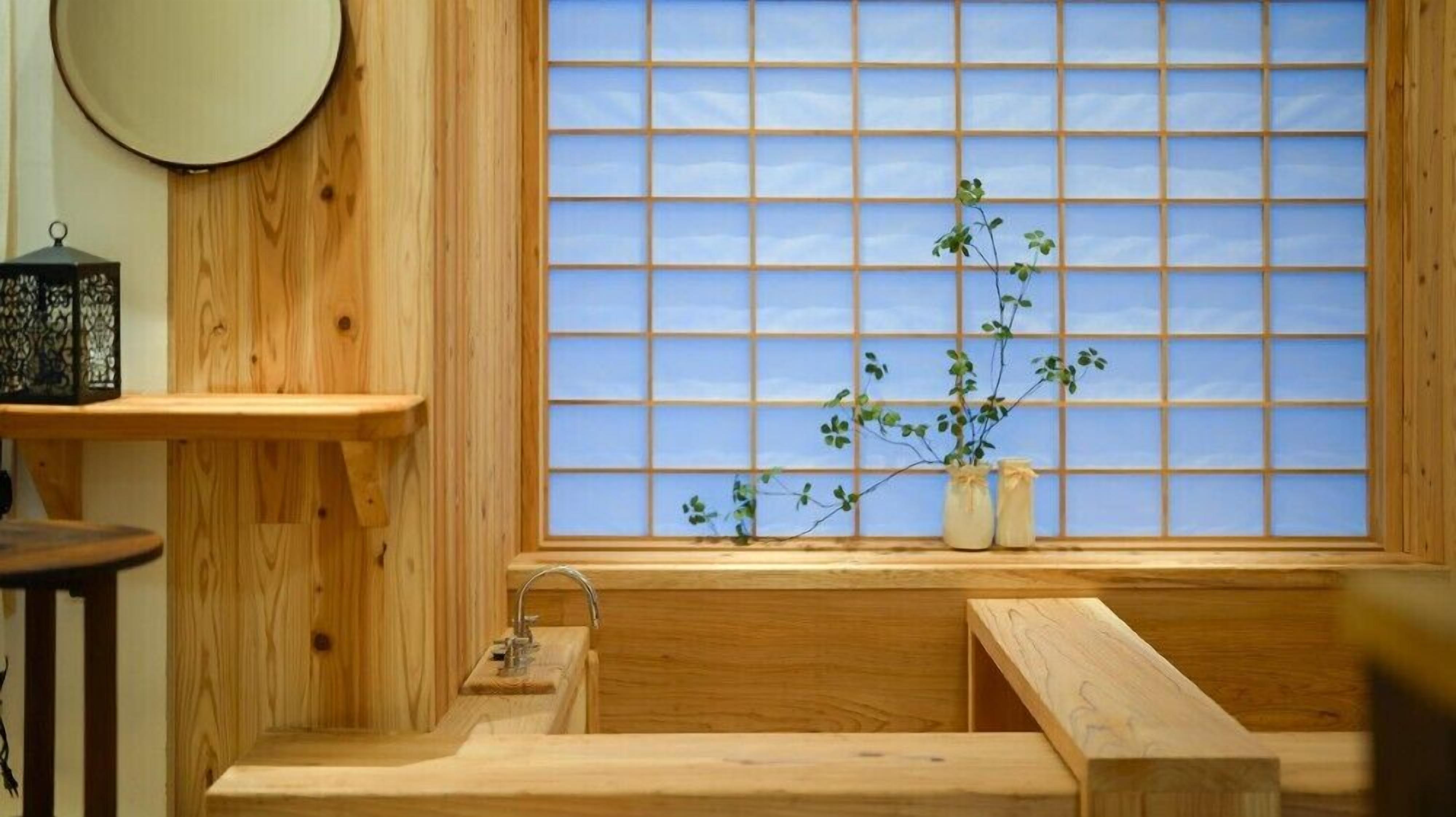 A traditional Japanese room with a wooden interior, a window with a grid pattern, and a small shelf with a lantern.