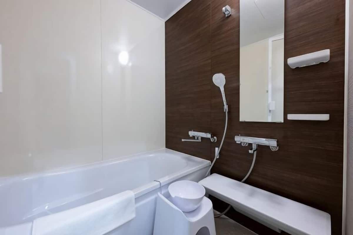 Une salle de bain moderne équipée d’une baignoire, de toilettes et d’un lavabo.