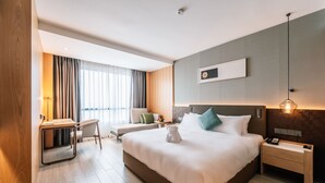 A modern hotel room with a large bed, bedside tables, a desk, and a chair. - Laike Hotel (Bangkok)