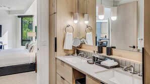 A modern bathroom with a large mirror, two sinks, and a vanity. - Electric Pass Lodge 607 (Snowmass Village)