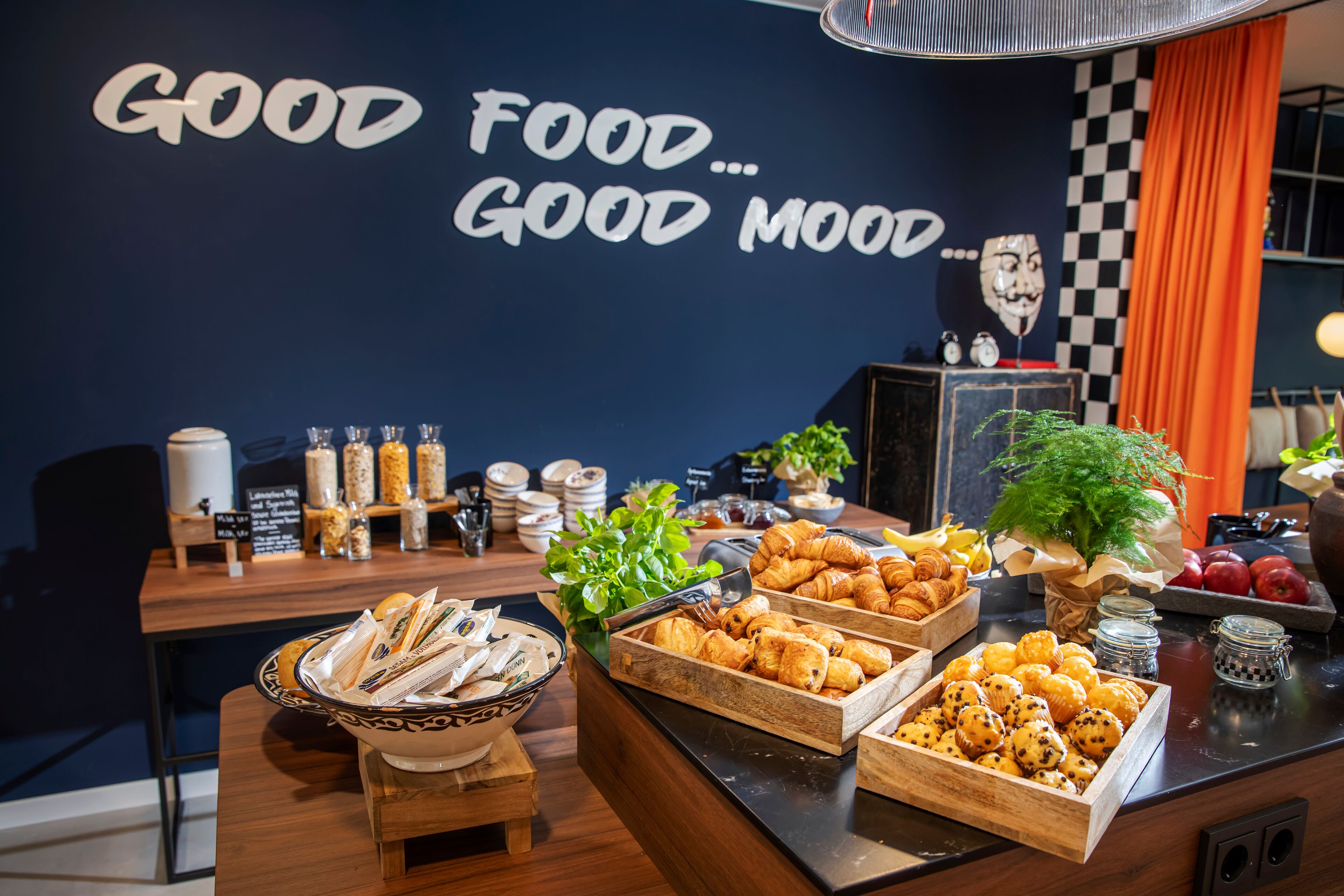 A buffet with various food items and a sign that reads "GOOD FOOD... GOOD MOOD."