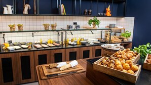 A kitchen counter with various food items and kitchen utensils.