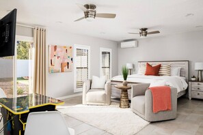 A bedroom with a bed, bedside tables, a desk, chairs, and ceiling fans. - Fun for the Whole Family w/Pool, Spa, Games + More (Scottsdale)