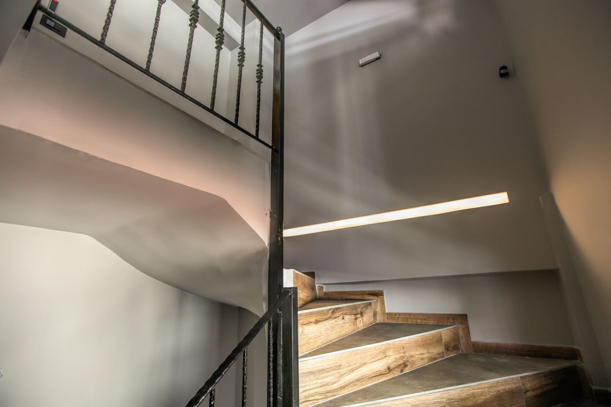A staircase with wooden steps and a metal railing.
