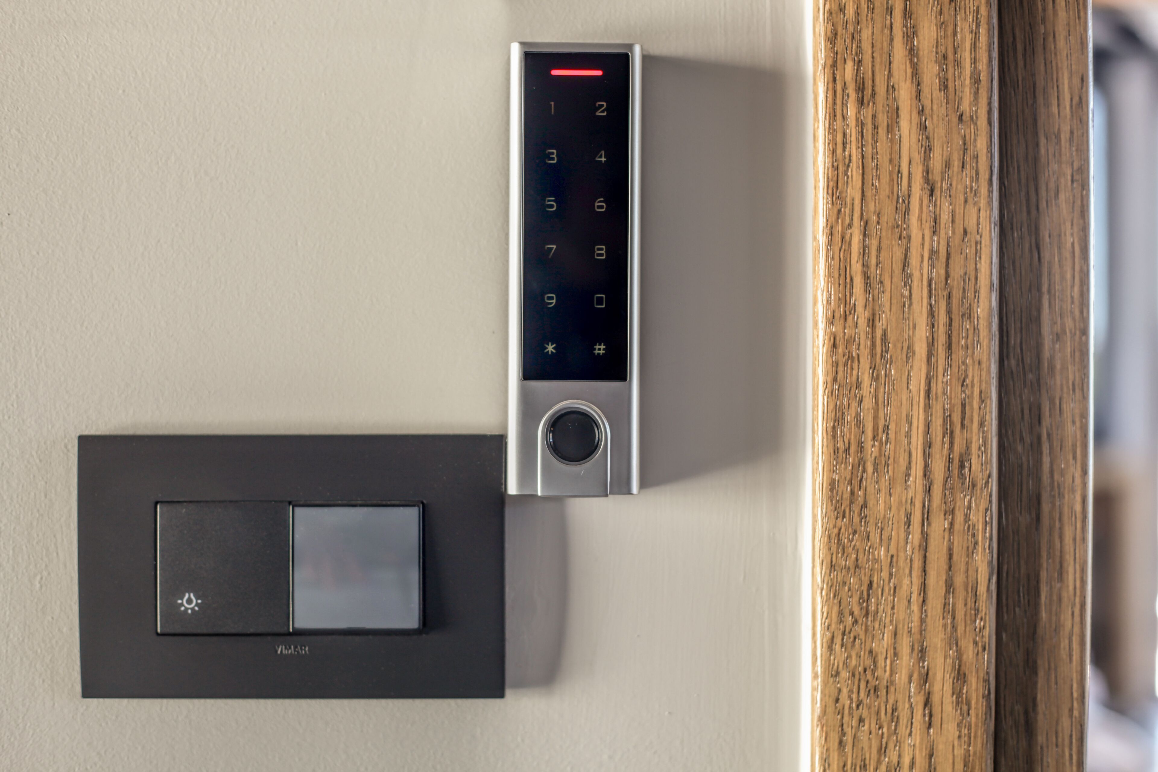A modern door lock with a keypad and a card reader.