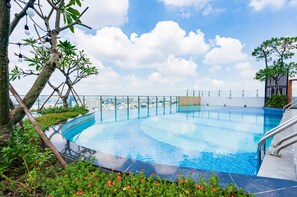 A rooftop infinity pool with a clear view of the city skyline.