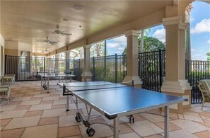 Relax in the outdoor recreational area, featuring a ping pong table and comfortable seating.