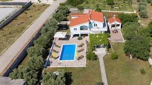 A residential property with a swimming pool, outdoor seating, and a garden. - Villa Marina (Sukosan)
