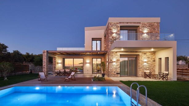 A modern two-story house with a swimming pool, outdoor seating, and a stone facade. - Alba Lilia (Πιτσίδια)