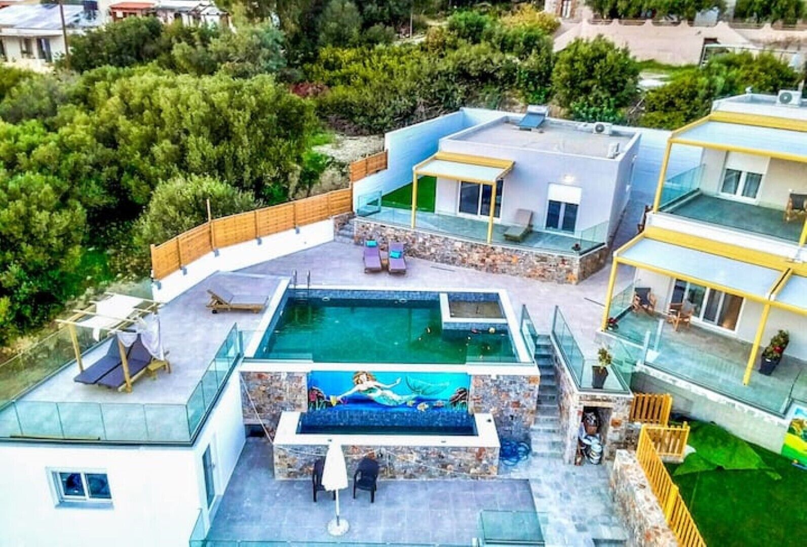 A modern residential property with a rooftop swimming pool, outdoor seating, and a landscaped garden.
