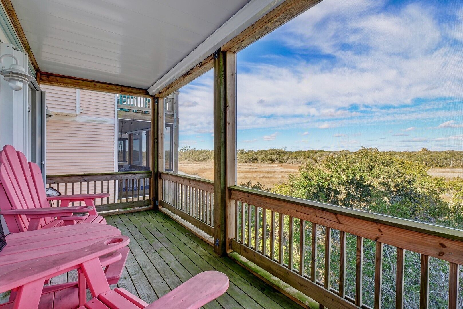 A covered porch with a view of a natural landscape.