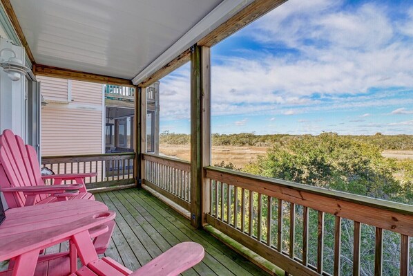 A covered porch with a view of a natural landscape.