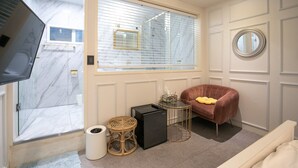 A modern bathroom with a glass shower enclosure, a built-in sink, and a vanity. - Bias K-GIRL GUESTHOUSE - Caters to Women (Seoul)