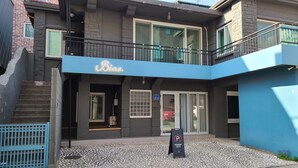 A building with a blue awning and a sign that reads "Bia." - Bias K-GIRL GUESTHOUSE - Caters to Women (Seoul)