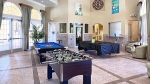 A spacious lobby with a foosball table, comfortable seating, and a billiards table. - Gorgeous 5bd Gm Spa Pool Hm Watersong-318ys 5 Bedroom Home by RedAwning (Davenport)
