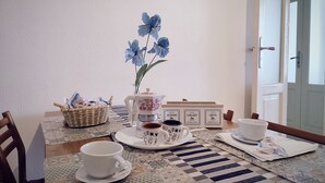 A dining table with a coffee pot, cups, and a basket of snacks. - Comfortable apartment in central area (Bari)