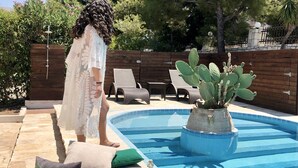 A poolside setting with a table set for breakfast, a cactus plant, and lounge chairs. - MyKosVilla with private pool (Kos)