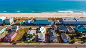 An aerial view of a coastal residential area with houses and a beach. - Toes in the Sand | Pet-Friendly Downtown Cottage Steps from the Beach! (Carolina Beach)