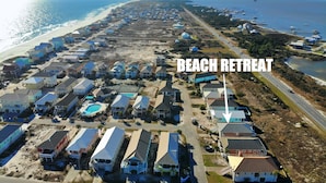 A beach retreat with multiple houses, a swimming pool, and a road leading to the beach. - Updated - Pools, tennis, beach! (Gulf Shores)
