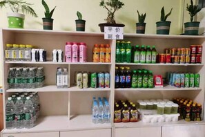 A shelf stocked with various beverages including sodas, juices, and energy drinks. - Lijiang Hotel (Xinyi Railway Station) (Xinyi)
